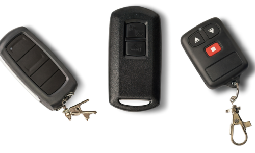 Three different car key fobs with attached metal keychains are displayed side by side on a white background, perfect for anyone looking for a reliable Locksmith in San Bernardino.